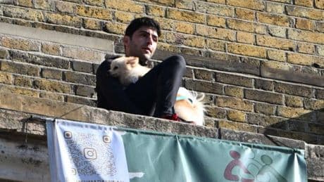 Protester climbs on King’s Cross station clocktower holding a dog