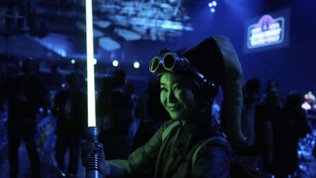 'Star Wars' fans wave lightsabers as an upcoming film gets announced in Japan
