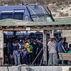 Newborn baby is among 27 dead after migrant boat capsizes off the coast of Italy - as the search for the missing continues into the night