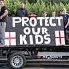 Anti-migrant protestors gather outside asylum seeker hotel for another day after Ethiopian man, 38, 'tried to kiss a 14-year-old girl'