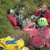 Rescuers work to free an injured cave explorer trapped more than 130 feet underground in Italy