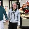Chris Hughes sweetly welcomes JoJo Siwa back to the UK with a bunch of red roses as the pair leave Heathrow hand in hand after confirming romance