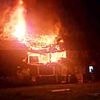 Moment house is destroyed in huge explosion that left two men with serious burns: Video shows debris flying across street before pair are spotted fleeing on foot