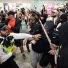 Child is pepper-sprayed by police at anti-migrant protest in Canary Wharf and cop is punched in the face as violence erupts in wake of Epping hotel ruling