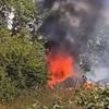 One dead after train 'with dozens of passengers onboard' ploughed into van at level crossing before vehicle 'burst into flames'