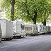 Fury as 'caravan dwellers' living on beloved green spaces wreck popular beauty spot - as hundreds of homeowners march in protest
