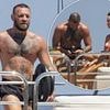 Shirtless Conor McGregor shares a kiss with fiancee Dee Devlin as they show off their affections on loved-up yacht holiday despite 'cheating' scandal and 'nudes' claims