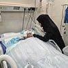 Doctor still fighting for his life after Israeli strike killed nine of his 10 children - as heartbreaking snap shows wife at his bedside