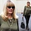 Playboy vet with an illustrious screen career steps out for rare outing in LA... can you guess who?