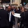 Moment Pope Leo is hit on the head by object thrown from a worshipper before another man yanks his arm with the new pontiff left begging for calm at the Vatican