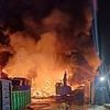 Crews tackle huge late-night blaze at industrial estate with warehouse, cranes and vehicles on fire