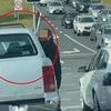 Wild moment two drivers launch into a fistfight at traffic lights in furious road rage incident before a high speed chase through the streets