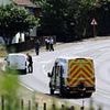 Police find at least four 'suspicious devices' at scene where gas mask-wearing plumber was shot while 'wielding a chainsaw'