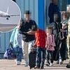 Pictured: The unmarked planes full of Afghans landing at Stansted's private hangers before migrant families are bussed to their new life in British hotels and military bases