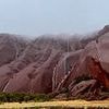 Stunning photos capture the rare moment water cascades down the sides of Uluru as mega rain bomb strikes Australia