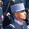 Moment bleeding soldier puts on a brave face during French Bastille Day celebrations as he continues marching with sword in hand