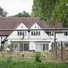 The sinister reason a 1930s mansion has been left empty for years...as newbuild estate springs up around it