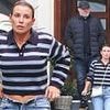 Coleen Rooney shows off her figure as she unbuttons her blue jeans after leaving a curry restaurant with husband Wayne