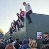 'You're my Wonderwall!': Oasis fans ignore security and climb barrier to try and see band play gig at Heaton Park