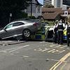 Emergency services rush to scene of high-impact crash as Mercedes lands on top of a police car - but miraculously both drivers walk away without serious injuries