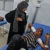 Six children among the dead after Israeli missile 'error' sees strike hit crowds of people queueing for water in Gaza