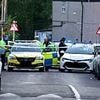 Girl, six, dies after being hit by Range Rover on busy road after school