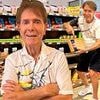 Sir Cliff Richard, 84, shows off his sweet side for 2026 calendar as he offers up biscuits and poses with wings for his highly anticipated annual photoshoot