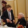 The King in training: Prince George, 11, is shown the ropes by Kate and William as he meets WWII veterans at VE Day tea party
