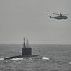 RAF scrambles spy planes as Britain joins huge NATO hunt for Russian sub 'suspected of threatening US aircraft carrier' off Norway