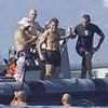French president Emmanuel Macron makes the most of his summer as he skips over the waves on his jetski... while Brigitte watches on