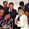 Moment jubilant Emmanuel Macron invites wife Brigitte to stand by his side during Champions League celebrations with PSG squad after tense week following 'slap' video and riots in France