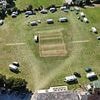 Fury as travellers 'break in' to cricket club before camping on the pitch and 'throwing rocks' at passers-by