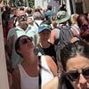 Europe's holiday hotspot hell: Videos show streets groaning with crowds and huge queues at famed beauty spots in Italy and Greece - despite raging anti-tourism protests