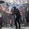 Riots break out across France as cops and protesters pelt each other with tear gas and projectiles during May Day marches