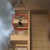 Shocking moment woman jumps from fifth floor of burning apartment block and SURVIVES