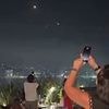 Surreal scenes in Lebanon as people party unfazed on rooftops under a sky of fiery missiles  hurtling towards Israel