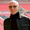 80s pop icon looks unrecognisable as he's pictured at Wembley stadium - but can you guess who it is?