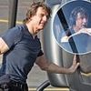 Tom Cruise shows off his 'top guns' in a tight navy T-Shirt as he lands his helicopter following a visit to Pinewood Studios - ahead of the release of his latest Mission: Impossible film