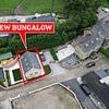 Owner of Grade II listed £800k estate at war with neighbours after building BUNGALOW in back garden without permission