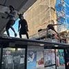 Notting Hill Carnival revellers dance on the top of a bus stop as thousands kick off celebrations at dawn