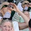 Hannah Waddingham, 50, downs a glass of wine as she enjoys a boozy day out at Wimbledon