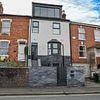 Homeowner ordered to take down dormer extension that looks like a 'football stadium executive box' after neighbours branded it 'a monstrosity'