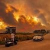 Travel chaos as wildfires tear through holiday hotspot and grounds flights leaving 100s of passengers stranded as Europe scorches... and Britain is set to hit record-breaking temperatures