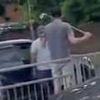 Moment angry driver gets in road rage row with rival motorist while armed with golf club