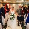 The wedding crasher is found: For four years this bride and groom pondered the identity of the dark-haired stranger at their nuptials - now they have discovered the hilarious truth
