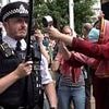 Moment pro-Palestine protester loudly bangs metal pot at Met Police officer - forcing him to shield his ears