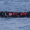 Germany to tighten people-smuggling law as chancellor visits UK