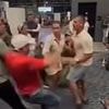 Brawl erupts in airport after man slapped woman for refusing to get up from seat next to his wife