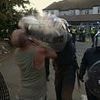 Moment riot police smash shield into man's face, knocking his teeth out during Epping migrant hotel clash after resident was charged with schoolgirl sex attack