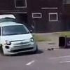 Terrifying moment Fiat speeds backwards and swerves onto grass verge as 60 masked youths riot after funeral of teen who died in crash